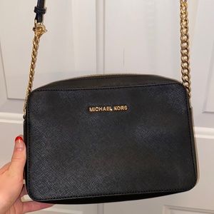 Micheal Kors black purse. Worn but in good condition.